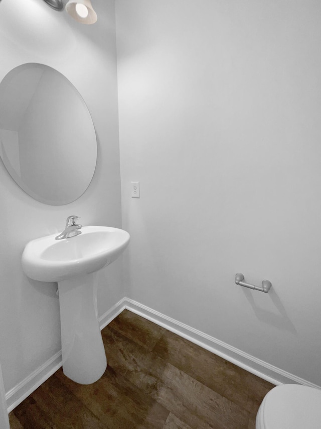 bathroom with baseboards and toilet