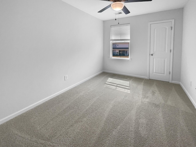 spare room featuring visible vents, ceiling fan, baseboards, and carpet floors