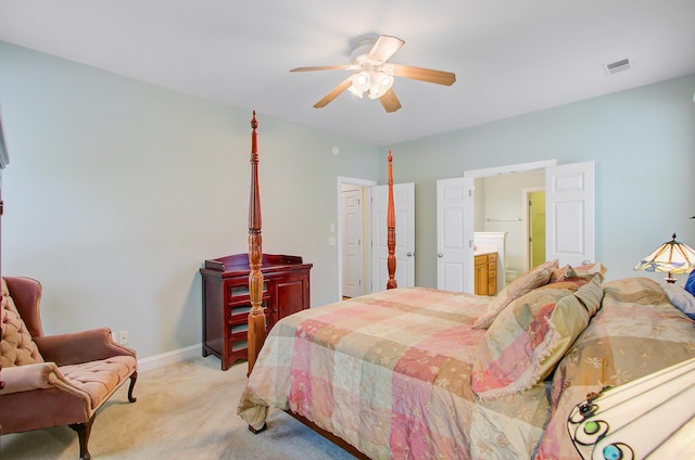 bedroom with baseboards, light carpet, ensuite bathroom, a ceiling fan, and visible vents