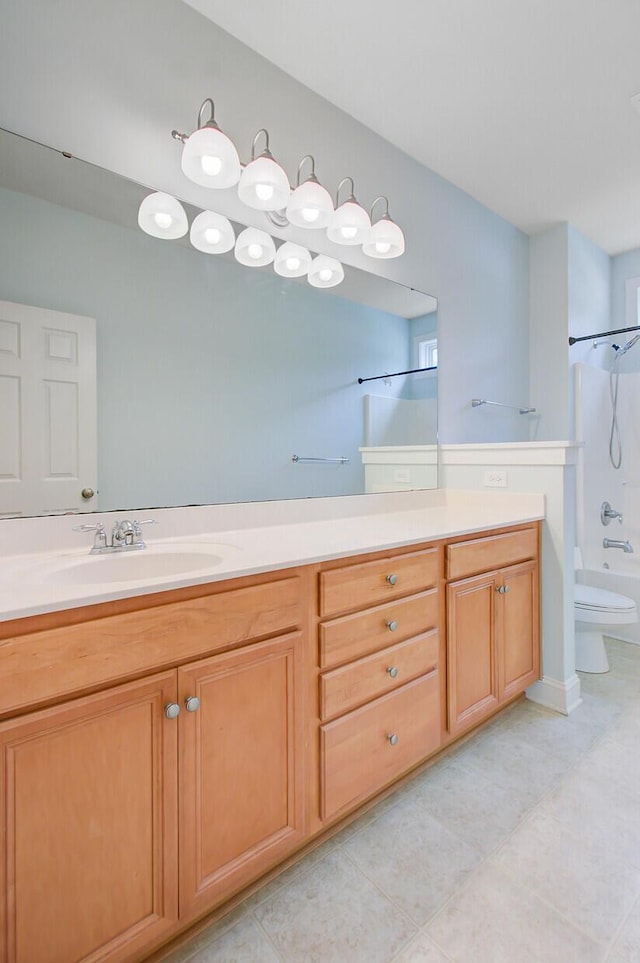 bathroom with toilet, tile patterned floors, vanity, and bathtub / shower combination