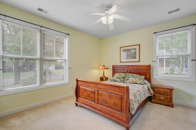 bedroom featuring light carpet, baseboards, and visible vents