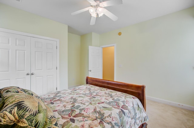 bedroom featuring a closet, baseboards, ceiling fan, and light colored carpet