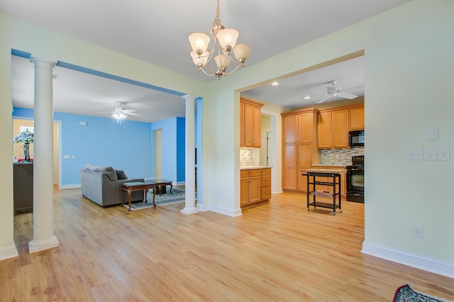 kitchen with decorative columns, ceiling fan with notable chandelier, black appliances, and decorative backsplash