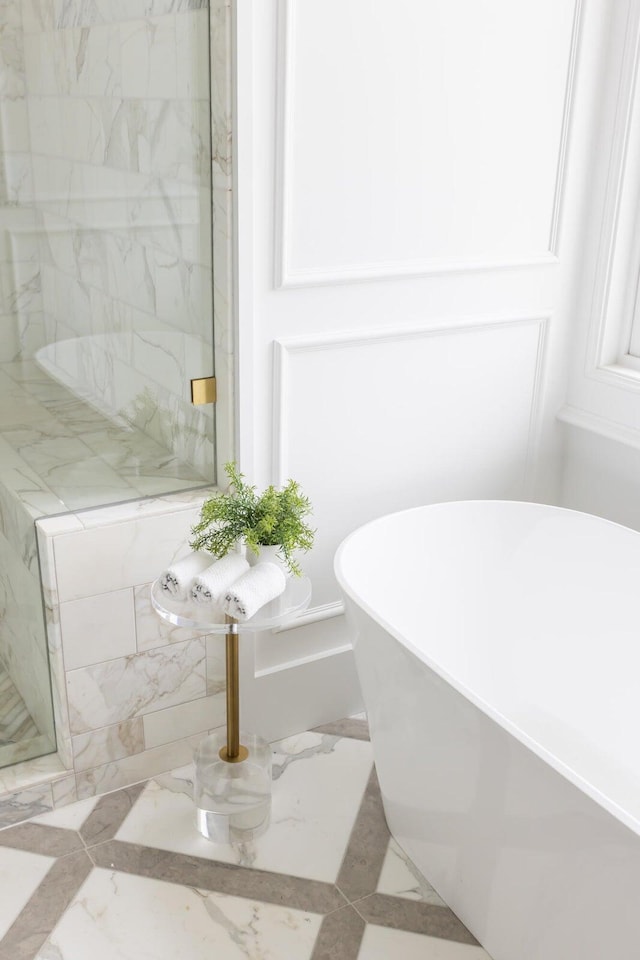 bathroom with tile floors and a bath