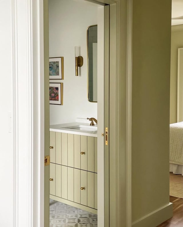 hallway with sink and light tile floors