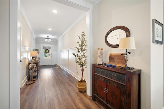 hall featuring dark wood-type flooring and ornamental molding