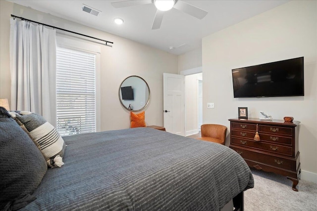 carpeted bedroom with ceiling fan and baseboards