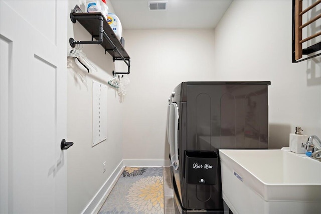 laundry room featuring washer and dryer and baseboards