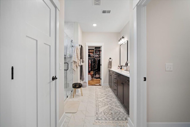 bathroom featuring an enclosed shower and vanity