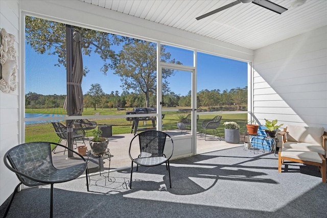 sunroom / solarium featuring ceiling fan