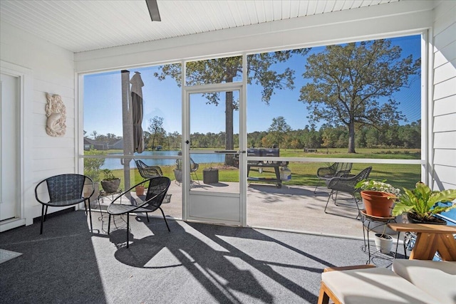 sunroom / solarium with a water view