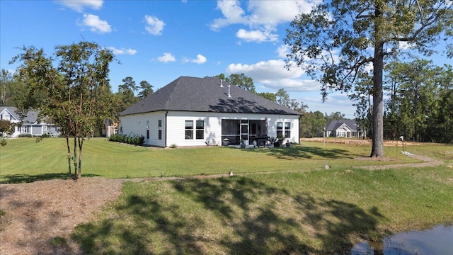 back of house featuring a lawn