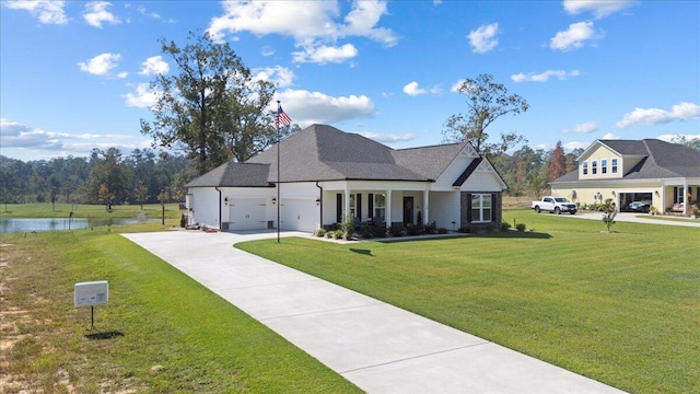 view of front of home with a water view, a garage, a porch, and a front lawn