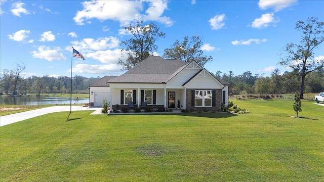 craftsman inspired home with concrete driveway, a front yard, a water view, covered porch, and a garage