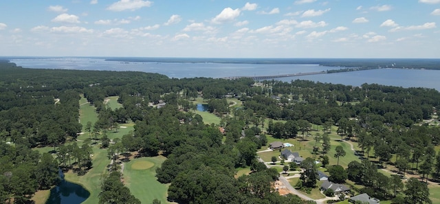 aerial view of property and surrounding area featuring a nearby body of water and a golf course