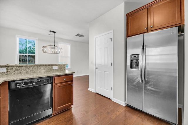 kitchen with dishwasher, hanging light fixtures, light stone countertops, dark wood-type flooring, and stainless steel refrigerator with ice dispenser