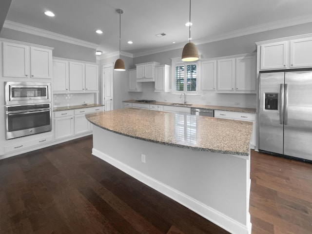 3700 Maidstone Dr, Mount Pleasant, SC 29466 - kitchen featuring appliances with stainless steel finishes, dark wood-style floors, crown molding, white cabinetry, and a kitchen island