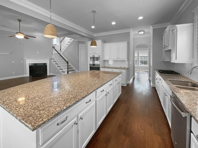 3700 Maidstone Dr, Mount Pleasant, SC 29466 - kitchen featuring arched walkways, a ceiling fan, a sink, stainless steel appliances, and dark wood-style floors