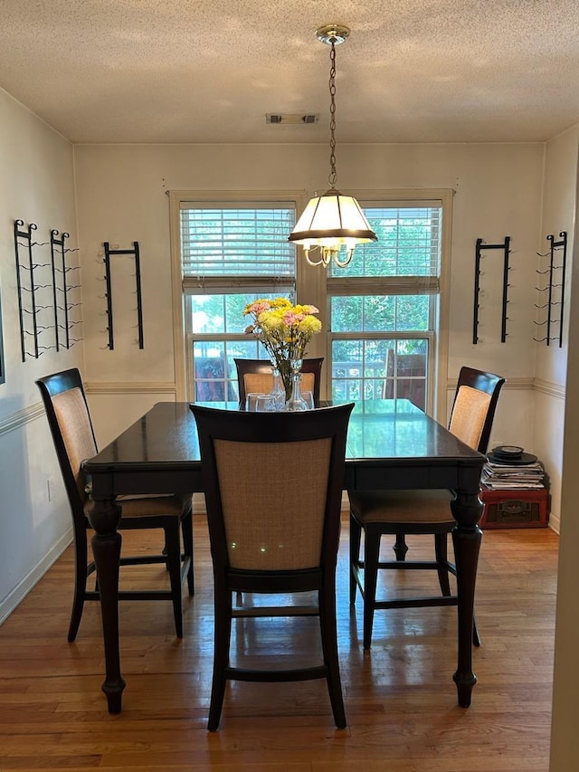 5423 Buckeye Rd, Hollywood, SC 29449 - dining room featuring a textured ceiling, wood finished floors, a chandelier, and baseboards