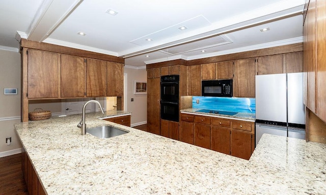 kitchen featuring sink, black appliances, kitchen peninsula, and light stone countertops