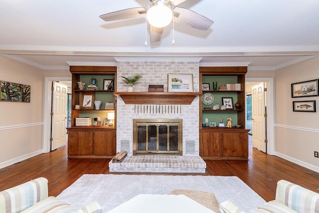 living room with a brick fireplace, dark wood-type flooring, ornamental molding, and ceiling fan