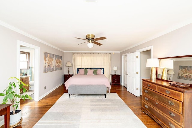 bedroom with ornamental molding, dark wood-type flooring, connected bathroom, and ceiling fan