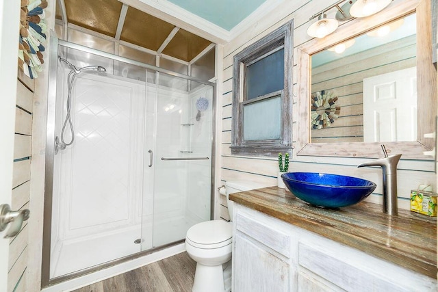 bathroom with vanity, wood-type flooring, toilet, and a shower with shower door