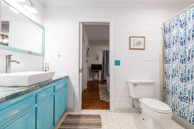 bathroom featuring ornamental molding, toilet, tile patterned flooring, and vanity