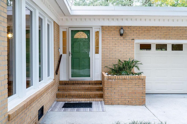 doorway to property with a garage