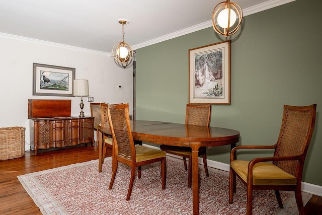 dining room featuring hardwood / wood-style floors and crown molding