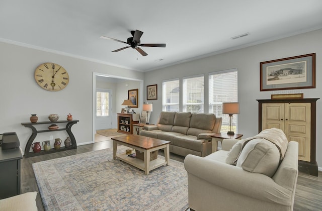 living room with ceiling fan, ornamental molding, and hardwood / wood-style floors