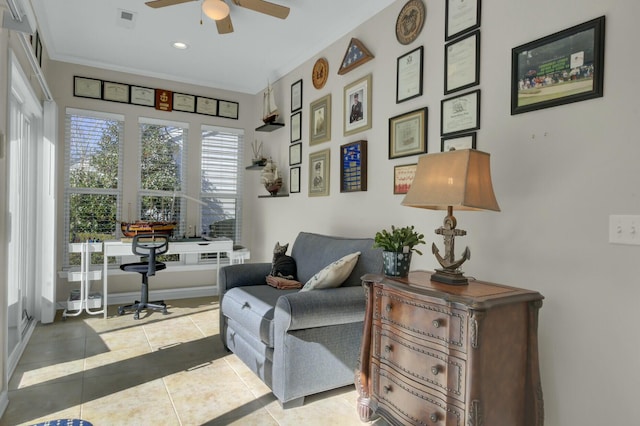 living area featuring light tile patterned floors and ceiling fan