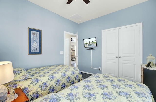 bedroom with ceiling fan and a closet