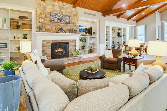 living room with a stone fireplace, built in features, lofted ceiling with beams, wood-type flooring, and wood ceiling