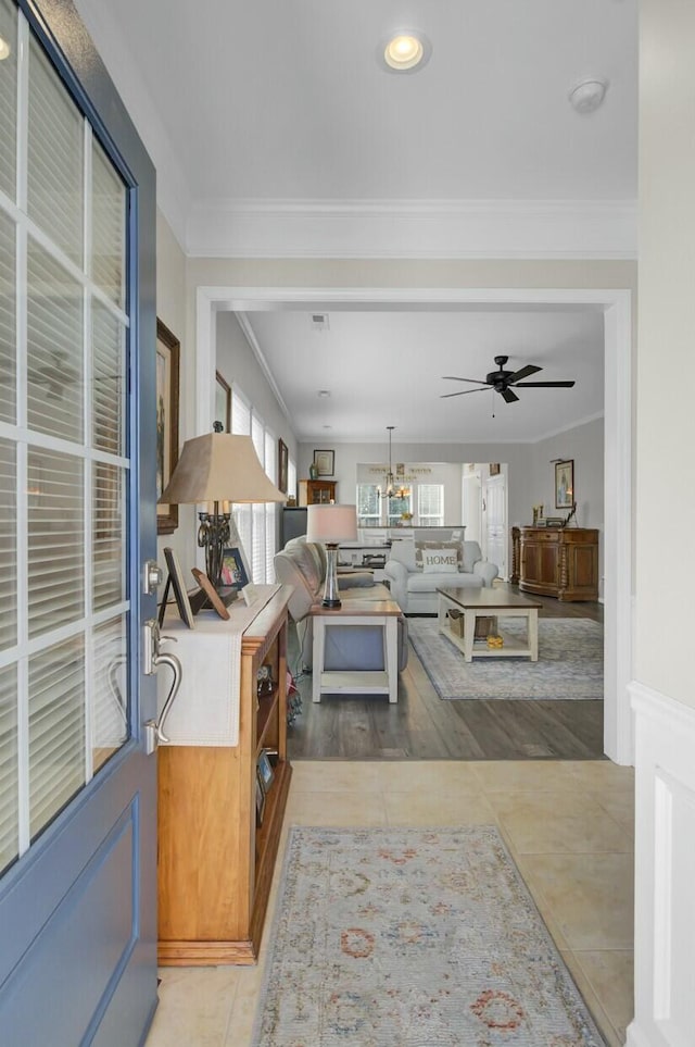 living room with crown molding and ceiling fan