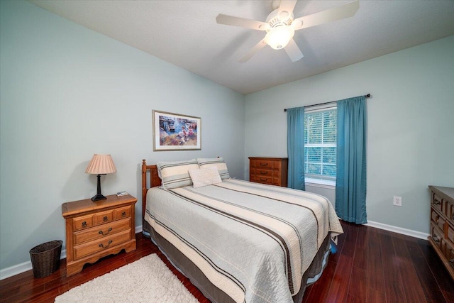 bedroom with ceiling fan and dark hardwood / wood-style flooring