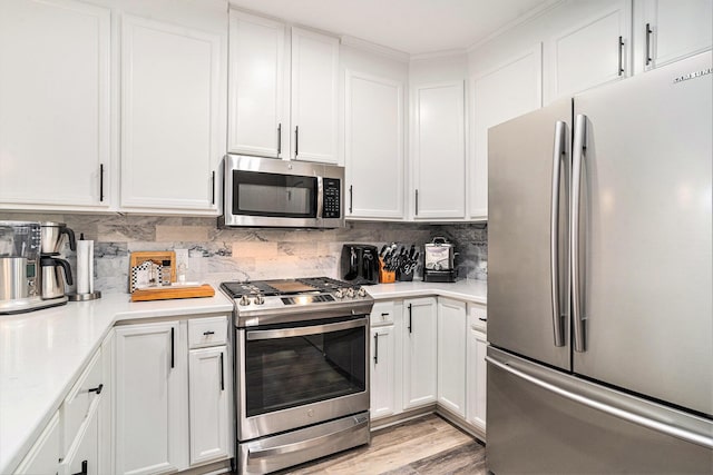 145 Pier View St Unit 111, Charleston, SC 29492 - kitchen featuring appliances with stainless steel finishes, light countertops, white cabinets, and tasteful backsplash