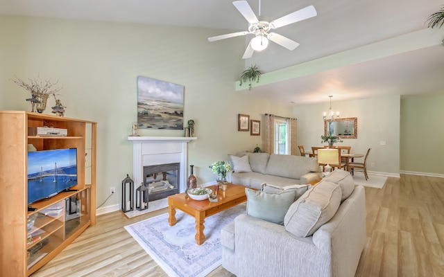 5347 Sundial Ct, North Charleston, SC 29418 - living room featuring light wood-style flooring, a chandelier, baseboards, a glass covered fireplace, and lofted ceiling
