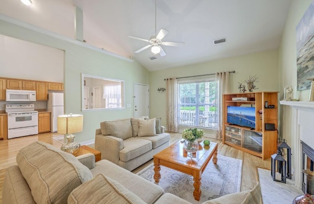 5347 Sundial Ct, North Charleston, SC 29418 - living area with light wood-style floors, a ceiling fan, a fireplace with flush hearth, and high vaulted ceiling