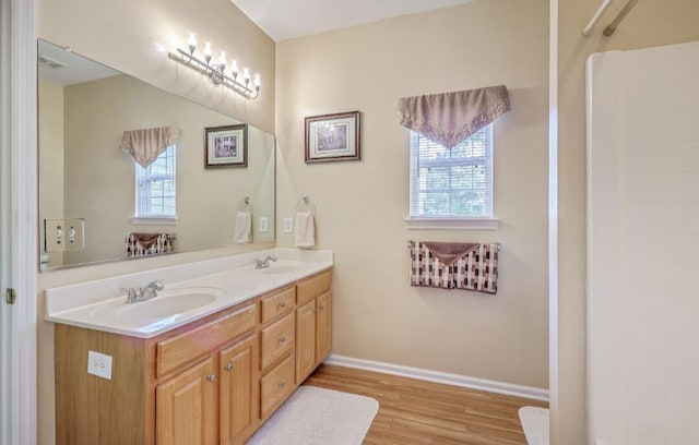 5347 Sundial Ct, North Charleston, SC 29418 - bathroom featuring wood finished floors, double vanity, and baseboards