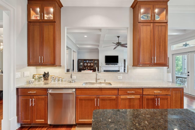 kitchen featuring glass insert cabinets, stainless steel dishwasher, and light stone countertops