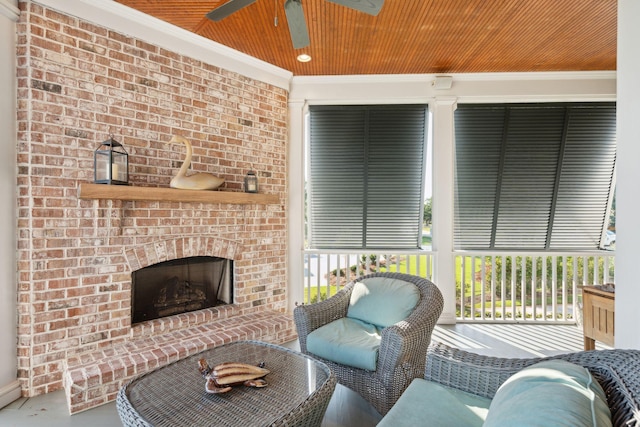 living room with ornamental molding, a healthy amount of sunlight, a fireplace, and a ceiling fan