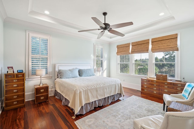 bedroom featuring dark wood-style floors, a tray ceiling, and baseboards