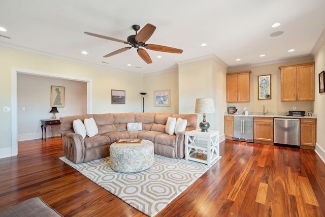 living room featuring indoor wet bar, crown molding, dark wood finished floors, recessed lighting, and baseboards