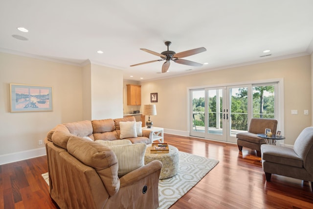 living room featuring dark wood-style floors, ornamental molding, and baseboards