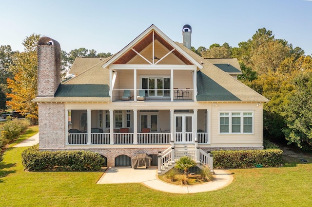 back of house with a patio, french doors, a chimney, and a lawn