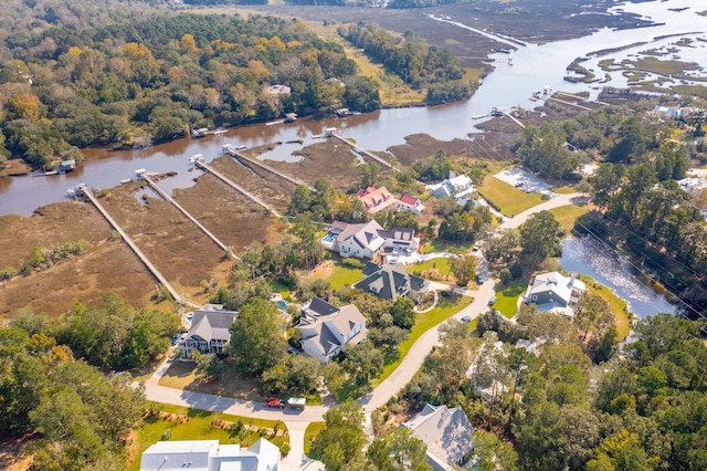 birds eye view of property featuring a water view and a forest view