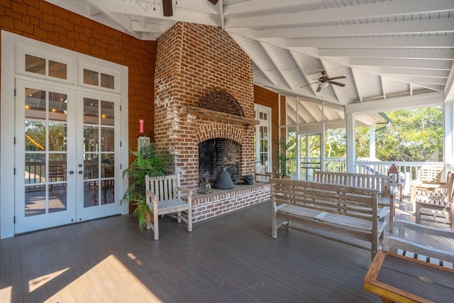 wooden deck with an outdoor brick fireplace, ceiling fan, and french doors