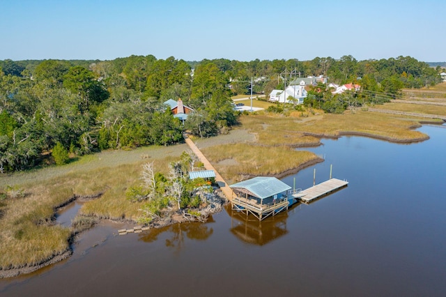 aerial view with a forest view and a water view