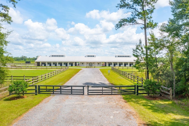 view of front facade with a rural view and a front lawn